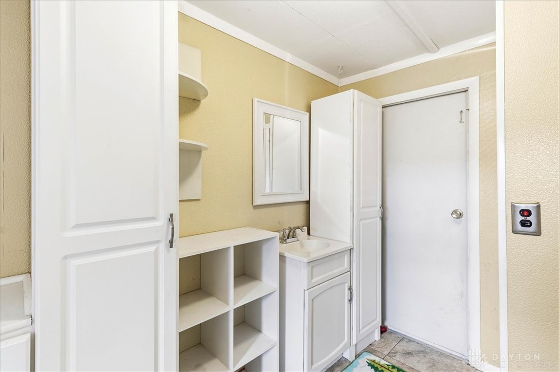 246 North Orchard Island Road Russells Point, OH 43348 - Photo 20 of 43 This functional utility room offers ample storage, a convenient sink, and durable tile flooring.