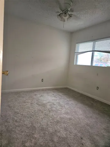 an empty room with a empty space and windows