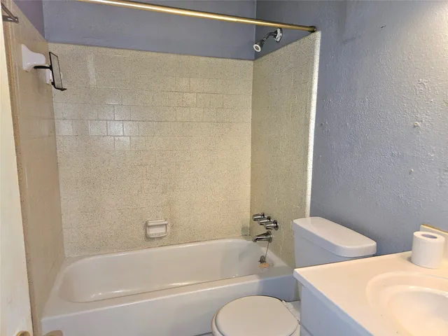 a white bath tub sitting next to a white toilet