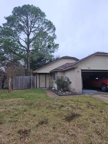 a front view of house with yard and trees