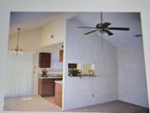 a living room with stainless steel appliances kitchen island furniture and a view of kitchen
