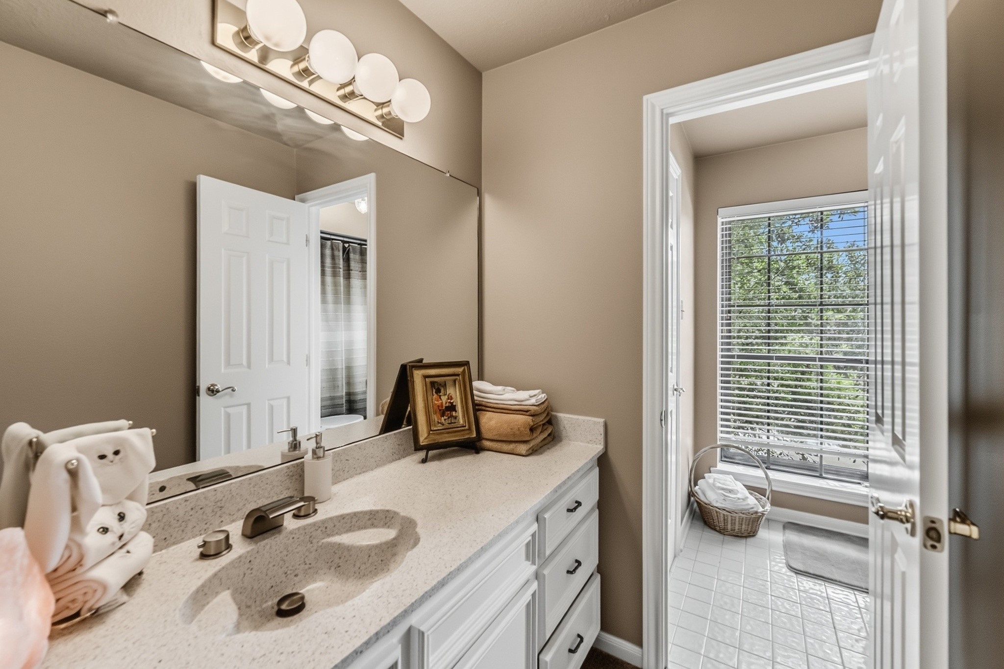 6047 Spring Creek Lane Spring, TX 77379 - Photo 31 of 50 Designed with a thoughtful Jack and Jill layout, each bedroom enjoys its own private vanity and sink area for added comfort and convenience. Warm finishes and timeless detailing keep the shared bath feeling both functional and well appointed.