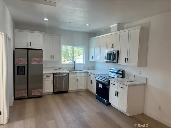 a kitchen with a sink a refrigerator and window