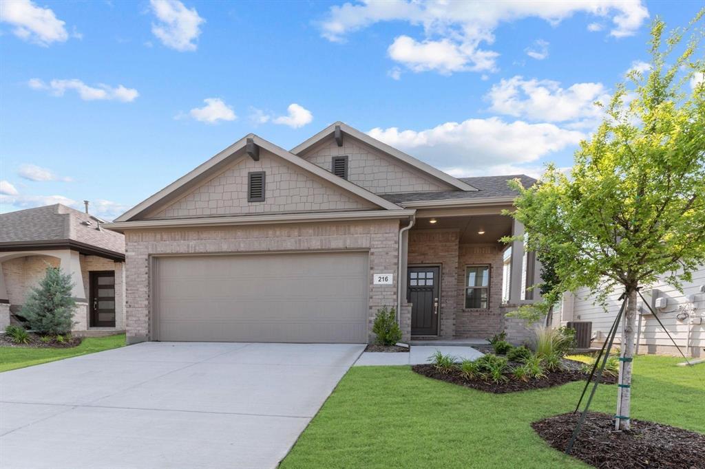216 Town Pk Avenue Princeton, TX 75407 - Photo 1 of 19 a front view of a house with a yard and garage