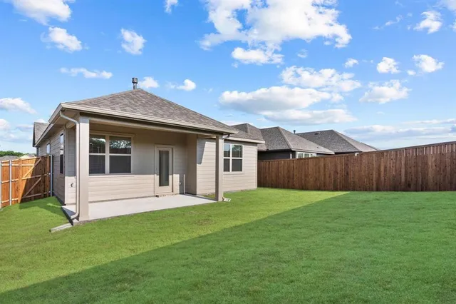 a view of a house with a yard and sitting area
