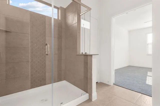 a bathroom with a bathtub and shower