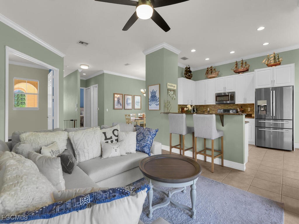 7241 Bergamo Way, Unit 201 Fort Myers, FL 33966 - Photo 1 of 26 a living room with furniture and kitchen view
