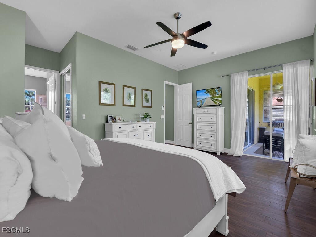 7241 Bergamo Way, Unit 201 Fort Myers, FL 33966 - Photo 13 of 26 a bed room with a bed and a chandelier