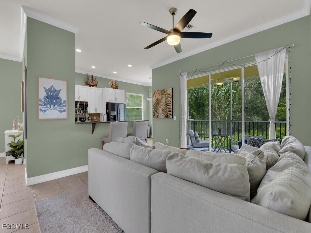 7241 Bergamo Way, Unit 201 Fort Myers, FL 33966 - Photo 2 of 26 a living room with furniture and a large window