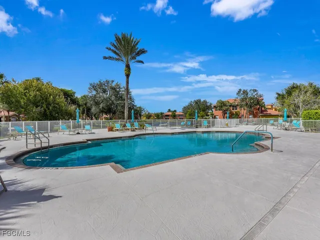 a view of swimming pool is middle in the garden