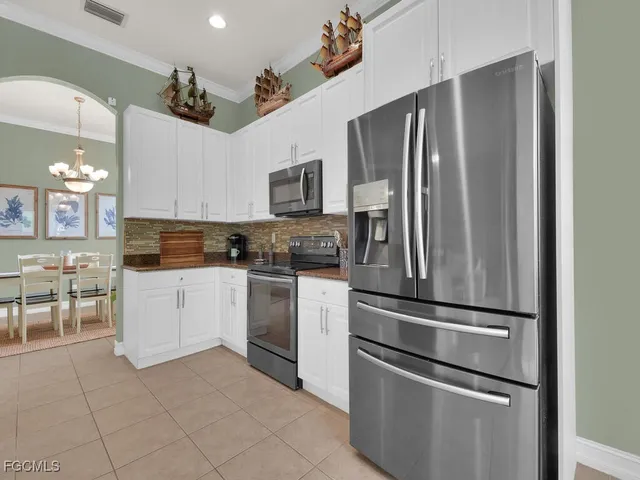 a kitchen with stainless steel appliances and refrigerator