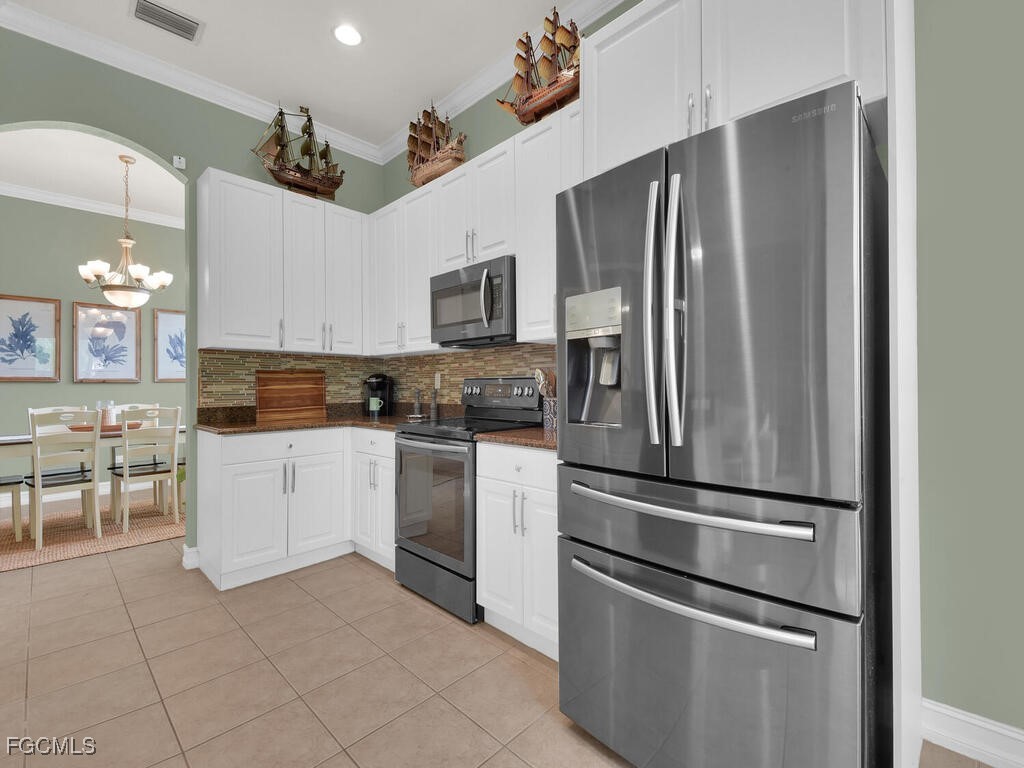 7241 Bergamo Way, Unit 201 Fort Myers, FL 33966 - Photo 7 of 26 a kitchen with stainless steel appliances and refrigerator