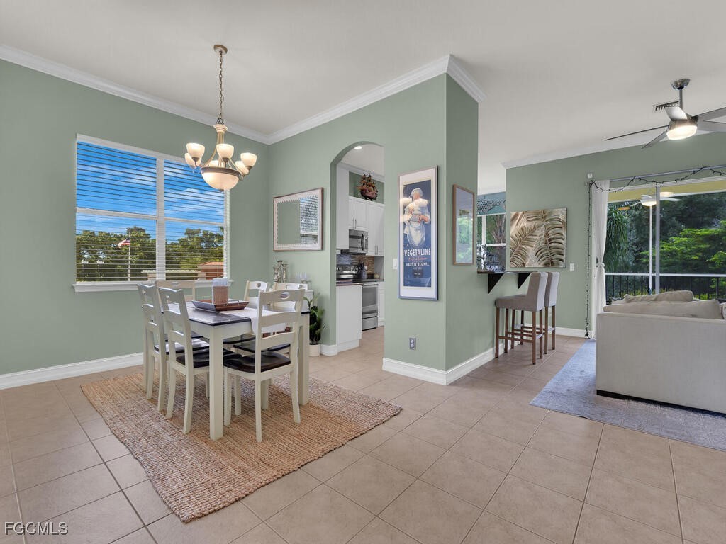 7241 Bergamo Way, Unit 201 Fort Myers, FL 33966 - Photo 8 of 26 a dining room with furniture a chandelier and window