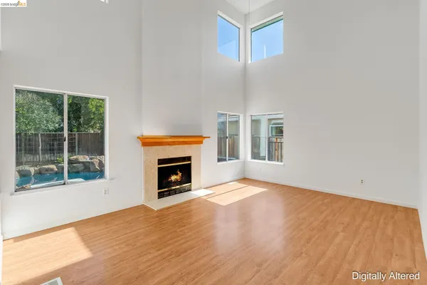 a view of an empty room with a fireplace and a window