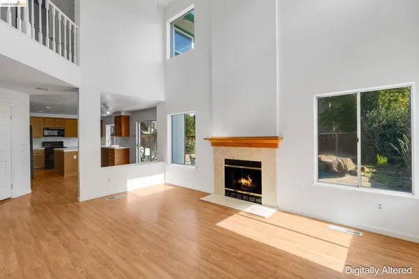 a large kitchen with stainless steel appliances granite countertop a stove a sink dishwasher and a refrigerator with white cabinets