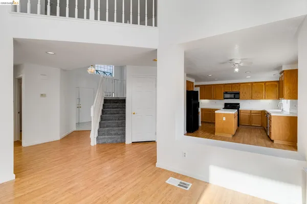 a kitchen with a sink a counter top space and stainless steel appliances