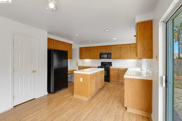a kitchen with stainless steel appliances a refrigerator and a stove