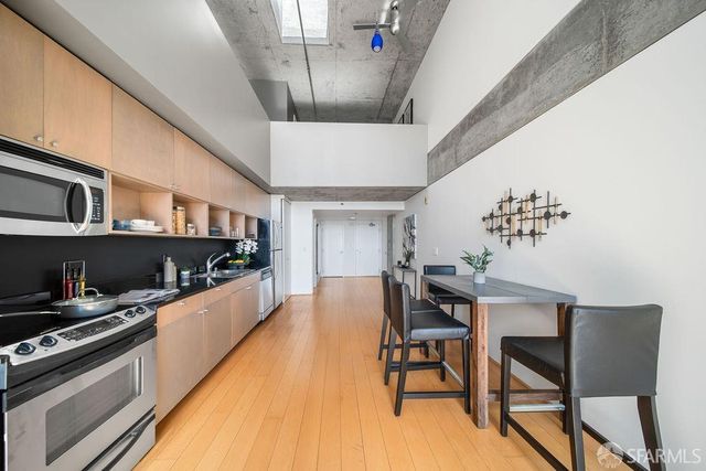 a dining room with stainless steel appliances kitchen island granite countertop furniture and a kitchen view