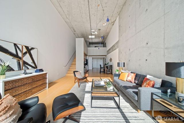a living room with furniture a rug and a chandelier