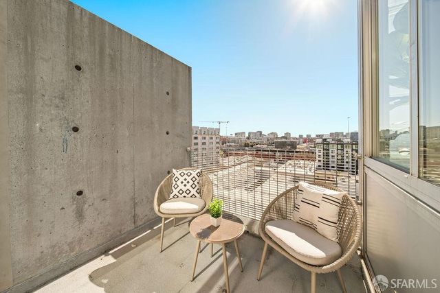 a balcony with a table and chairs