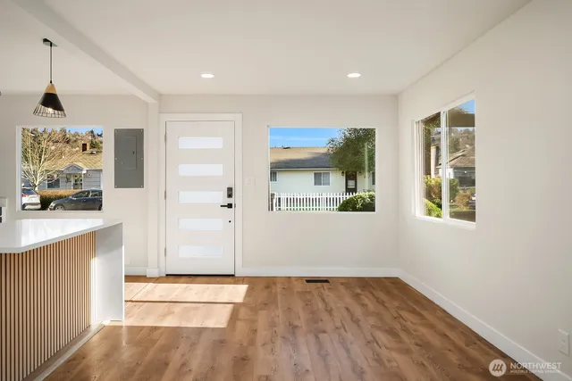 wooden floor in an empty room with a window