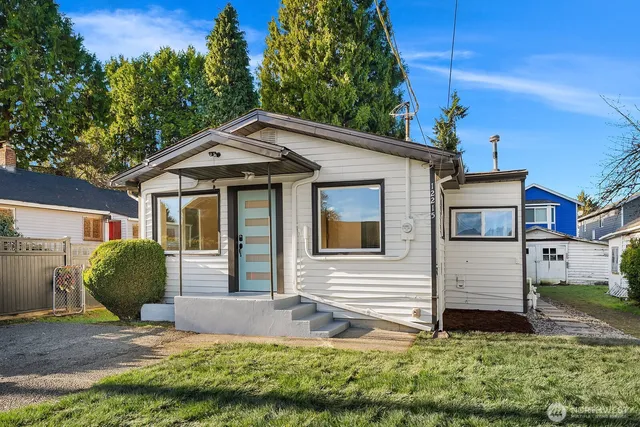 a house that has a tree in front of the house