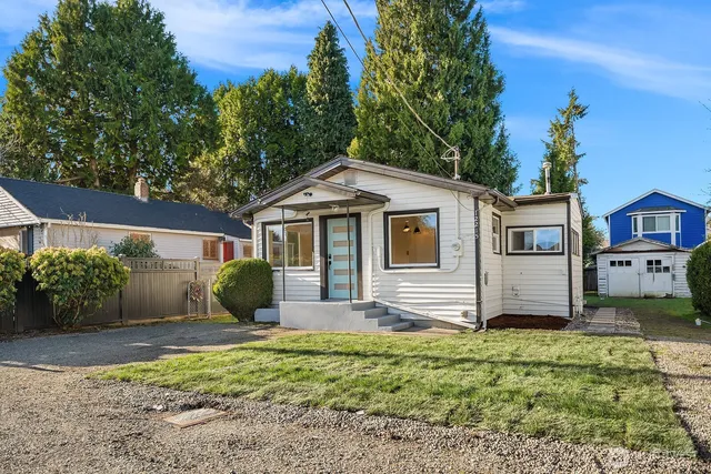 a front view of a house with a garden