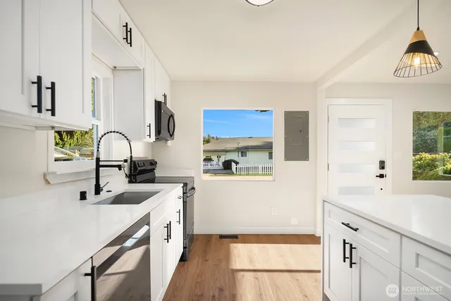 a kitchen with a sink stove and cabinets