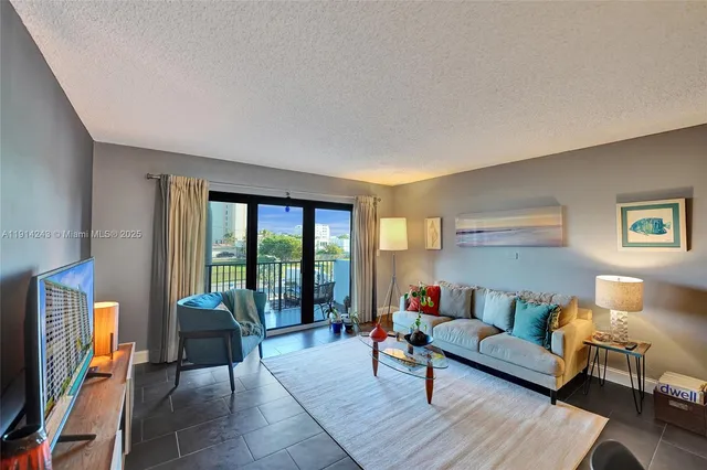 a spacious bathroom with a granite countertop sink and a painting on the wall