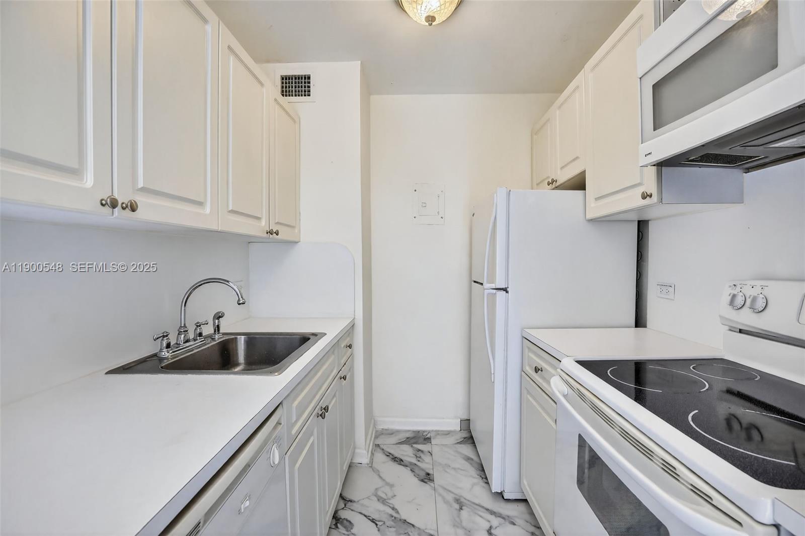 1405 Miami Road, Unit 5 Fort Lauderdale, FL 33316 - Photo 13 of 25 a kitchen with stainless steel appliances granite countertop a sink stove and refrigerator