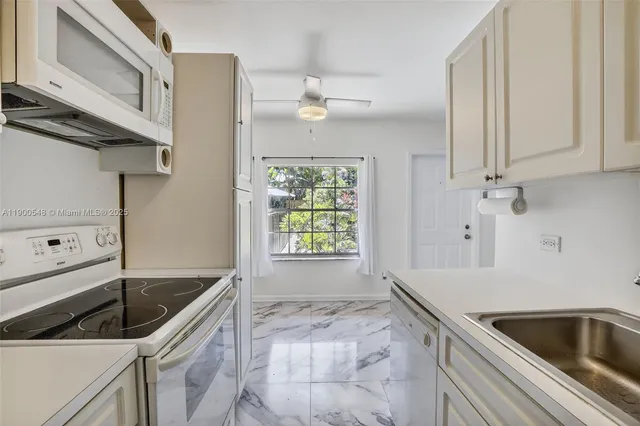 a kitchen that has a sink and a stove