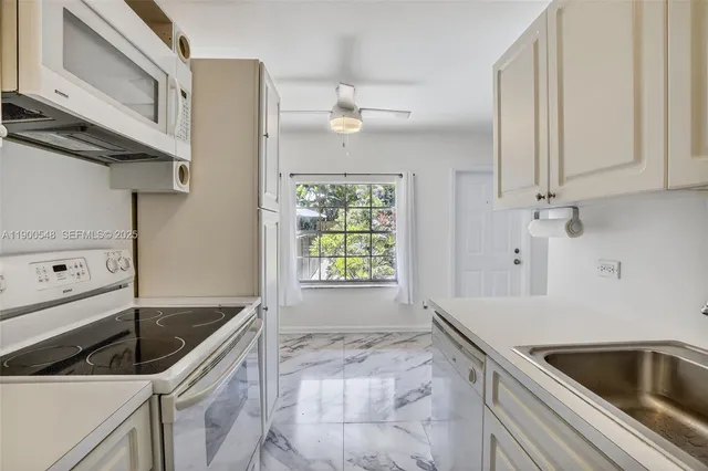 a kitchen that has a sink and a stove