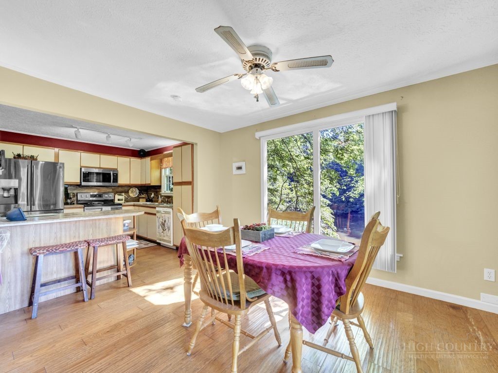 265 Trout Lake Road Deep Gap, NC 28618 - Photo 15 of 50 a view of a dining room with furniture window and wooden floor