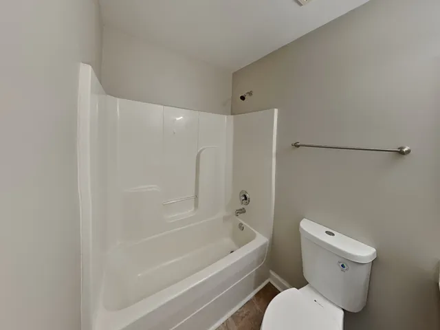 a bathroom with a toilet and a bathtub