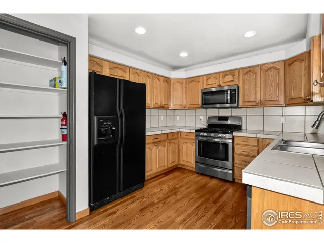 a kitchen with a refrigerator stove and a sink