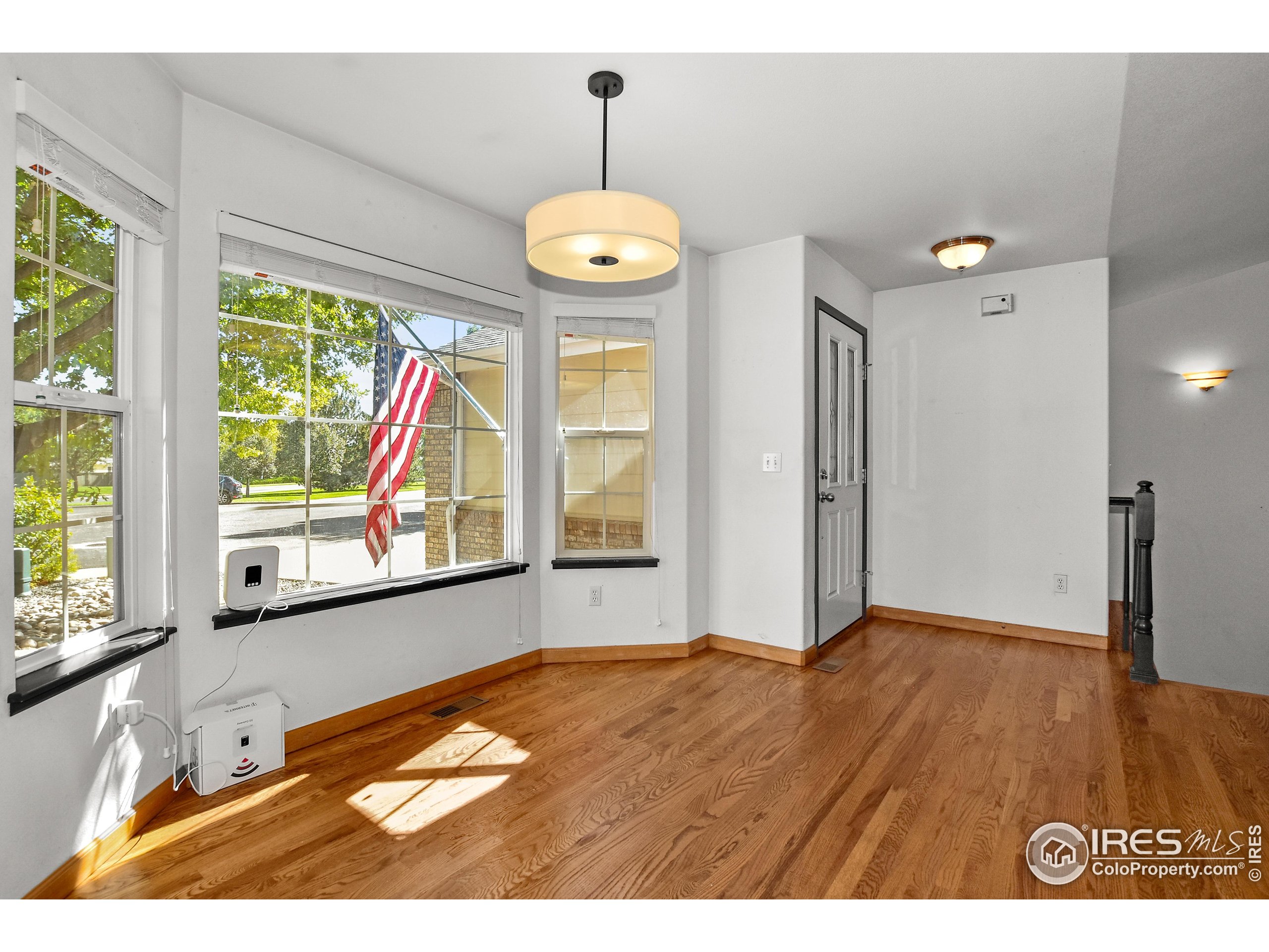 205 Timber Ridge Court Severance, CO 80550 - Photo 16 of 48 a view of an empty room with a window and wooden floor