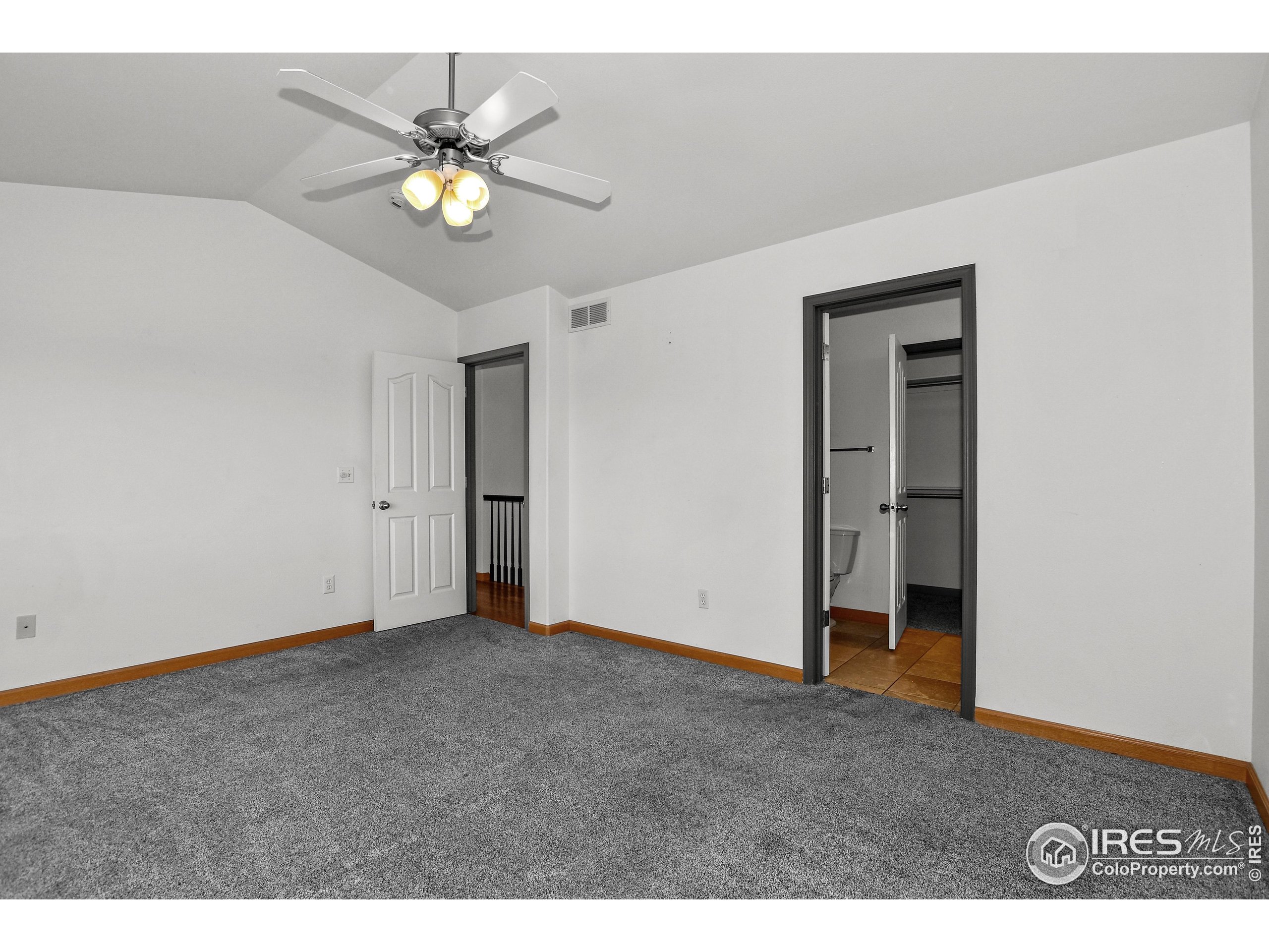 205 Timber Ridge Court Severance, CO 80550 - Photo 17 of 48 a view of an empty room with chandelier fan