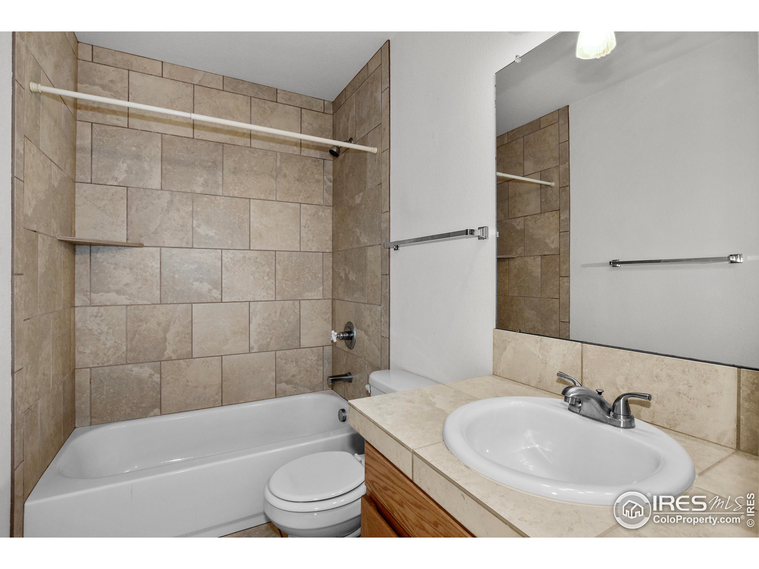 205 Timber Ridge Court Severance, CO 80550 - Photo 22 of 48 a bathroom with a sink toilet and shower