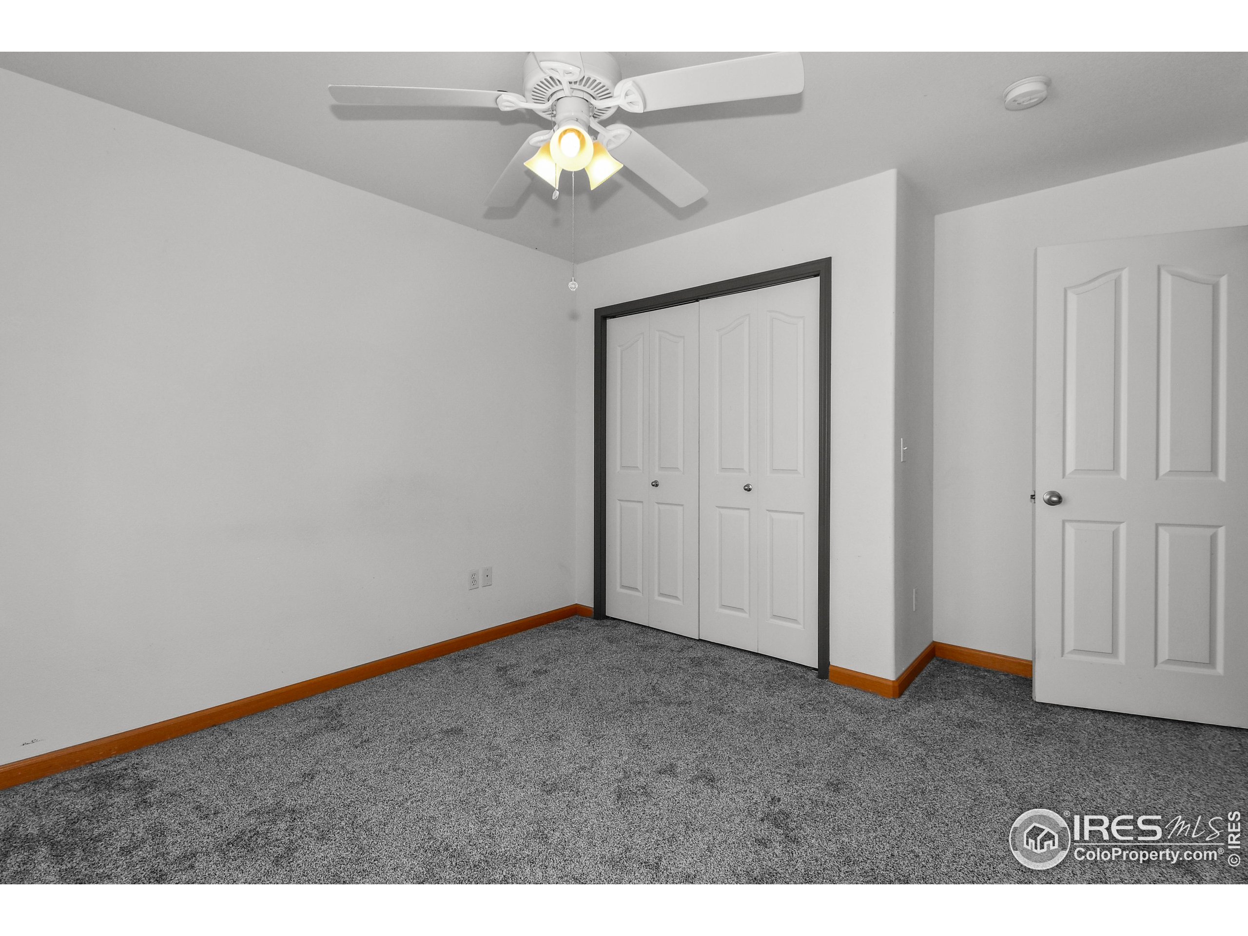 205 Timber Ridge Court Severance, CO 80550 - Photo 25 of 48 a view of an empty room with a chandelier fan