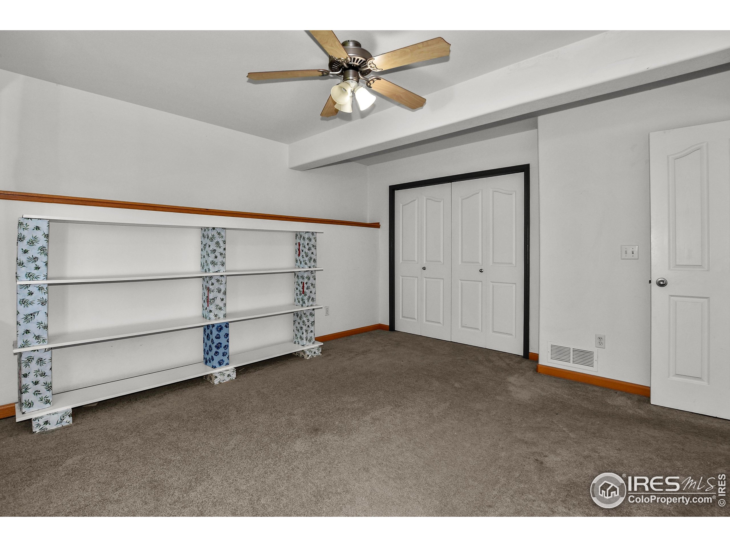 205 Timber Ridge Court Severance, CO 80550 - Photo 34 of 48 a view of an empty room with a ceiling fan