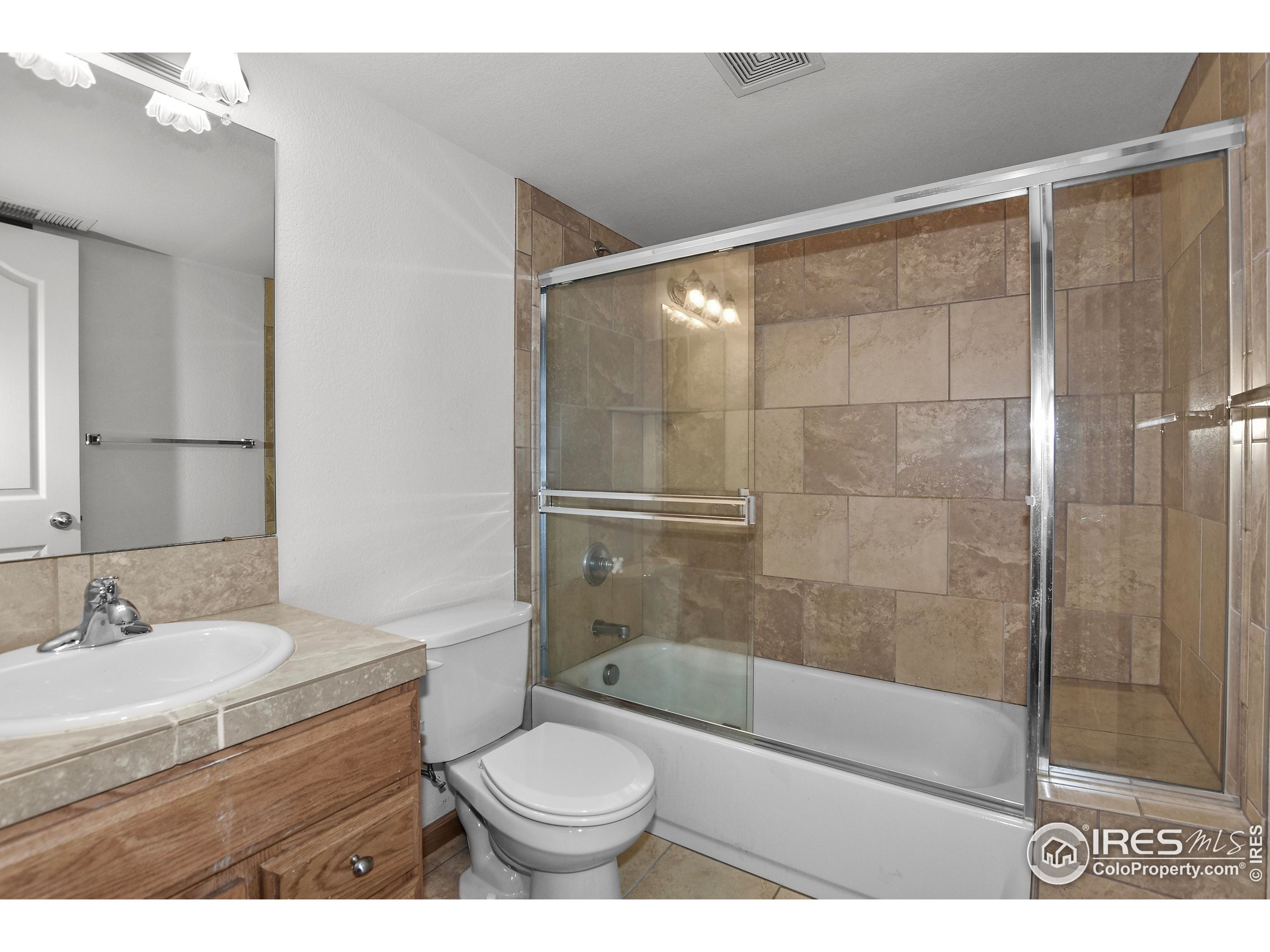 205 Timber Ridge Court Severance, CO 80550 - Photo 35 of 48 a bathroom with a granite countertop sink toilet and shower