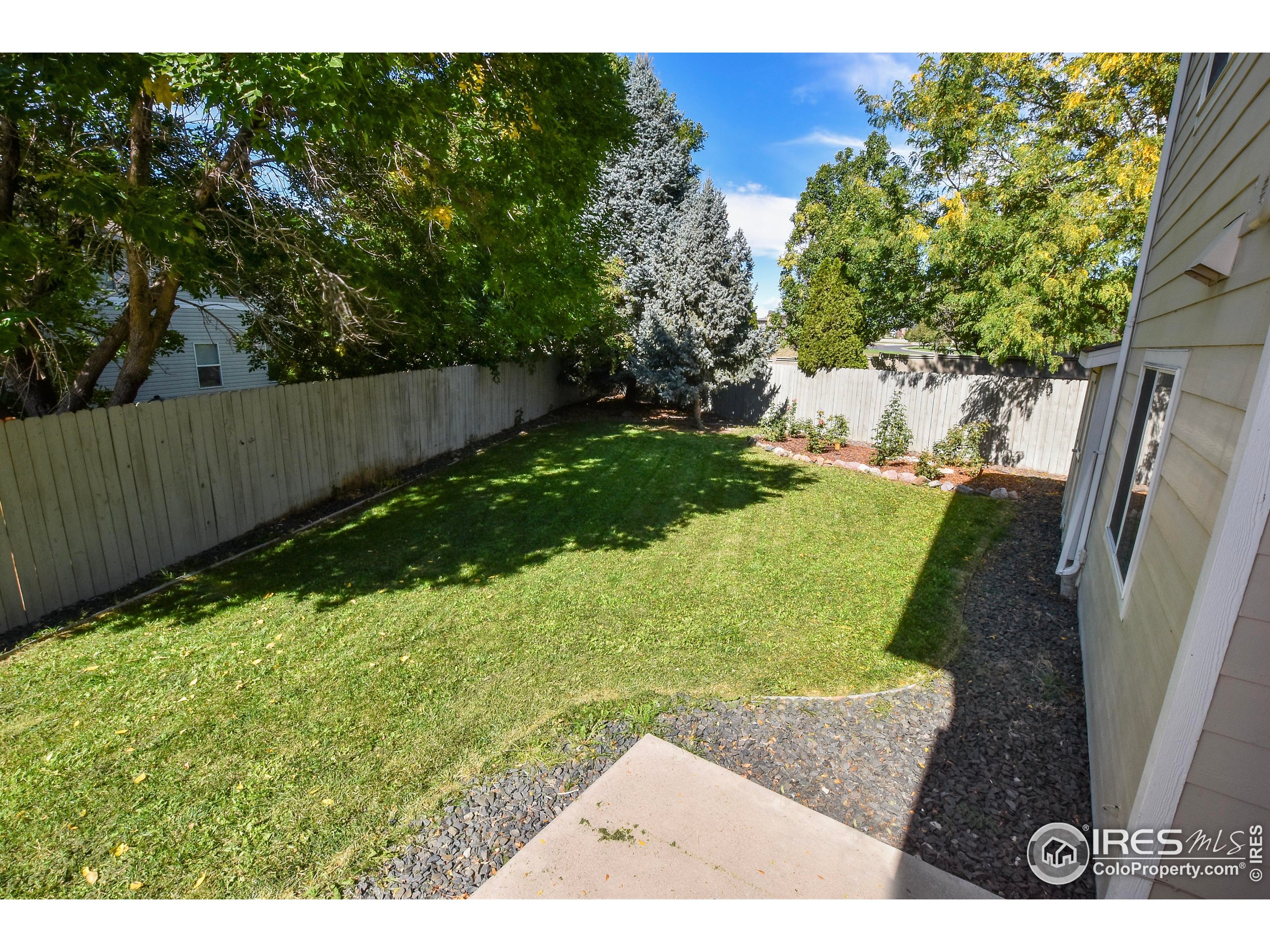 205 Timber Ridge Court Severance, CO 80550 - Photo 40 of 48 a view of a backyard with slide