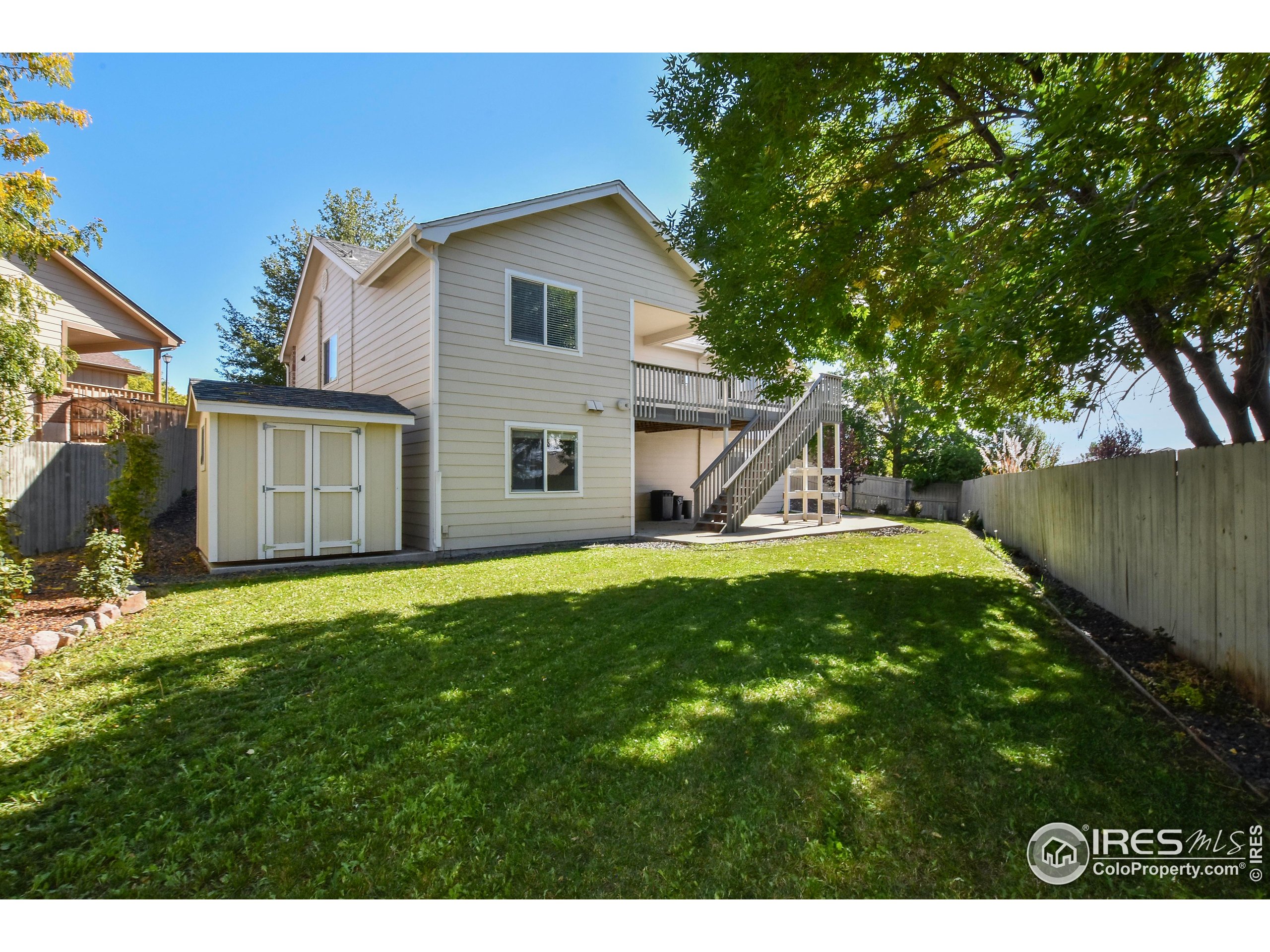 205 Timber Ridge Court Severance, CO 80550 - Photo 43 of 48 a view of a house with a backyard