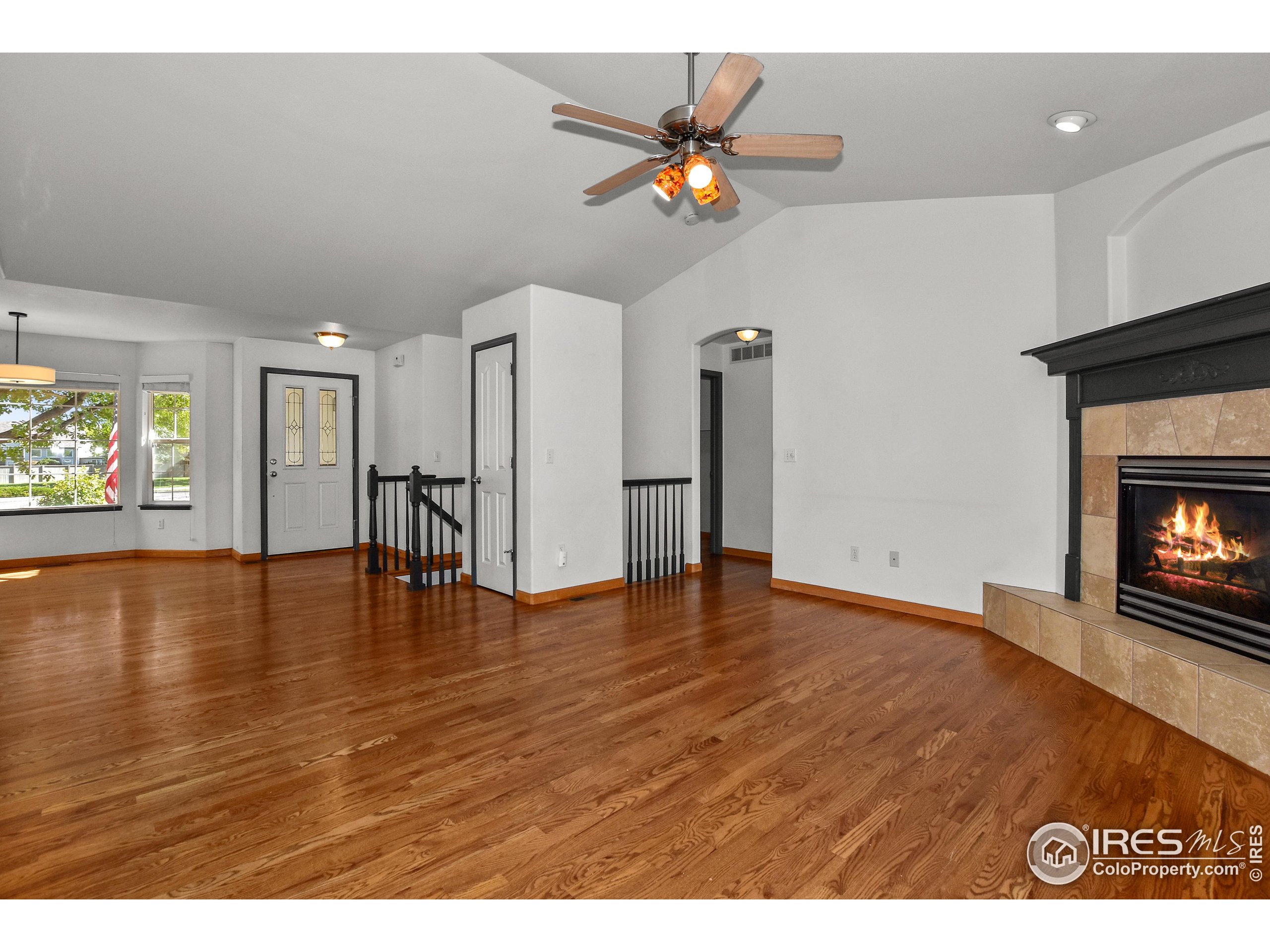 205 Timber Ridge Court Severance, CO 80550 - Photo 5 of 48 a view of an empty room with wooden floor and a fireplace