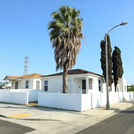 1350 East 94th Street Los Angeles, CA 90002 - Photo 1 of 15 a front view of a house with a yard and garage