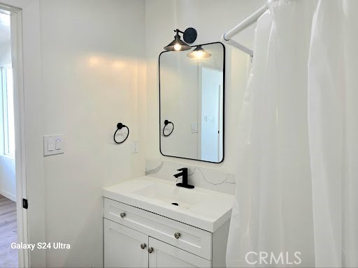 1350 East 94th Street Los Angeles, CA 90002 - Photo 14 of 15 a bathroom with a sink vanity and a mirror