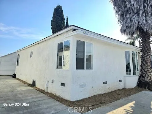 a view of a grey house with a yard