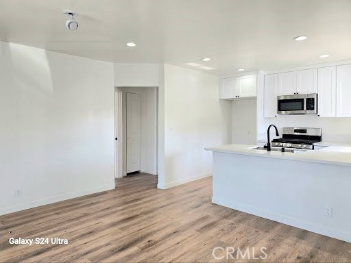 1350 East 94th Street Los Angeles, CA 90002 - Photo 4 of 15 a kitchen with stainless steel appliances granite countertop a stove a sink and a refrigerator