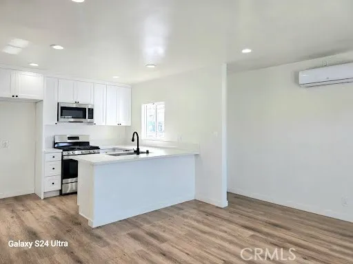 a kitchen with granite countertop a sink cabinets and stainless steel appliances