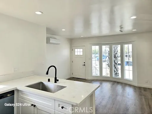 a kitchen with granite countertop a stove and a sink